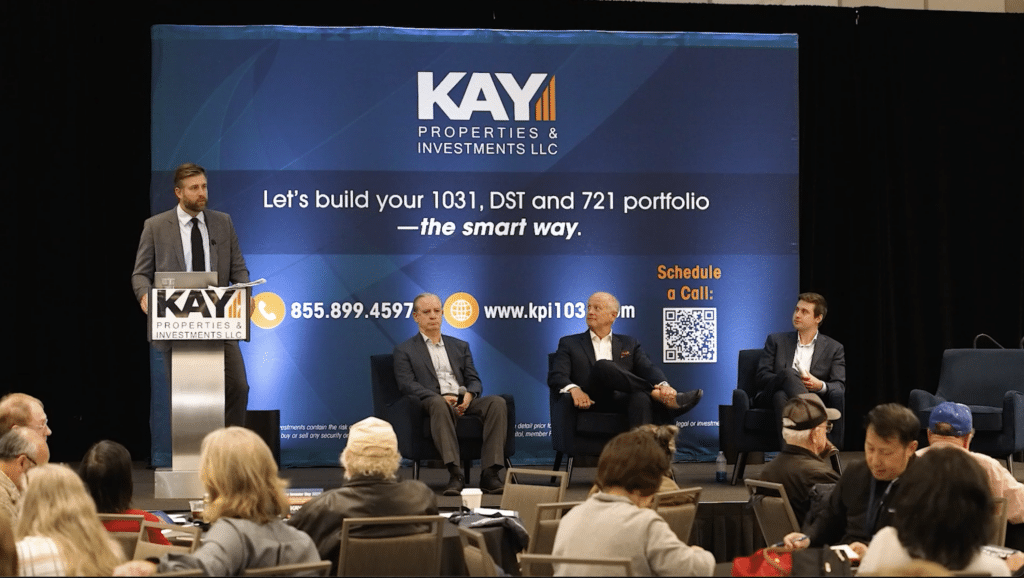 Image of Chay Lapin speaking at the podium for 721 UPREIT Insights