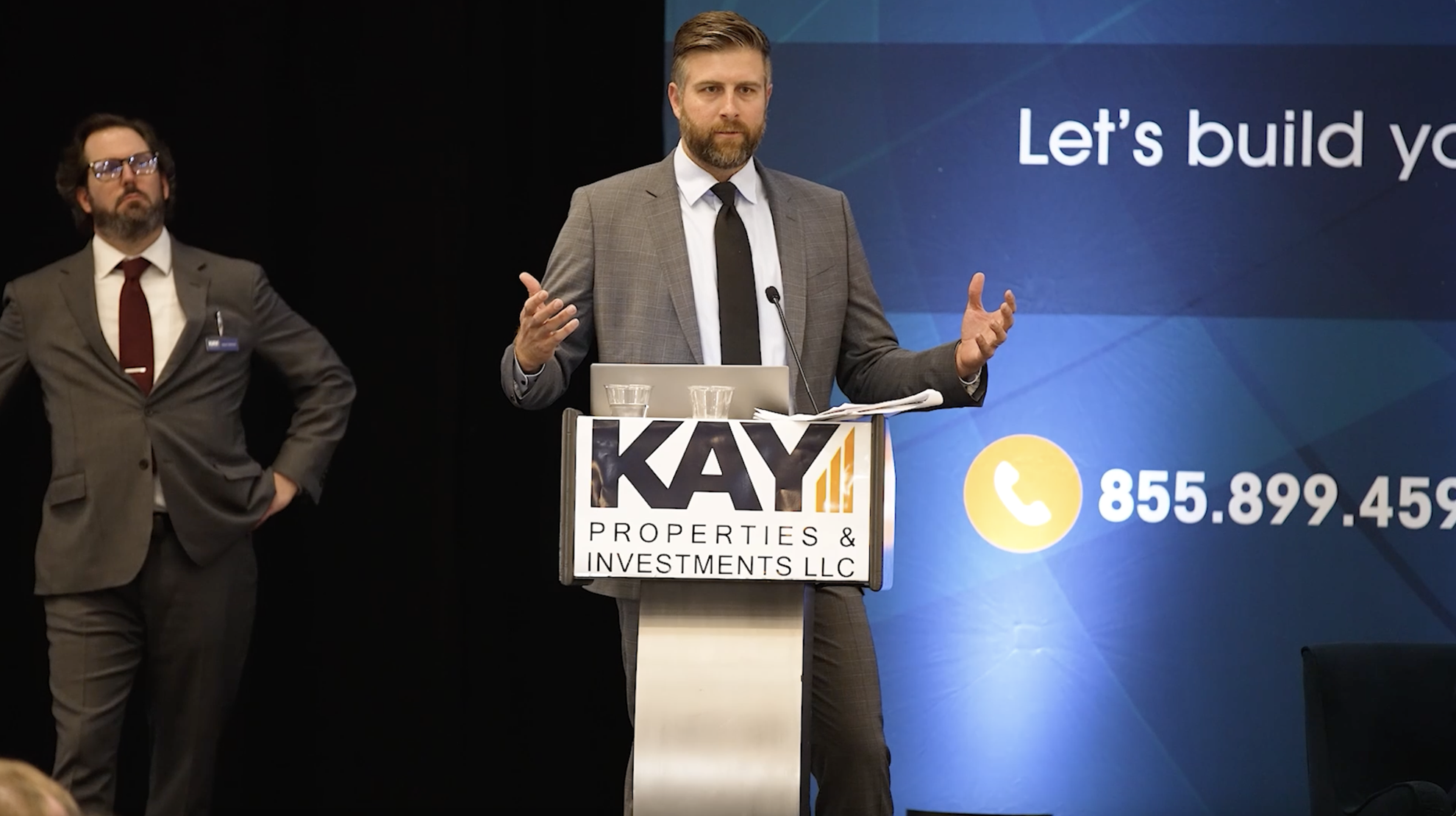 Image of Chay Lapin speaking at the podium to accredited investors