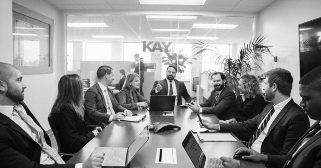 Dwight Kay attending a meeting with the Kay Properties and Investments team