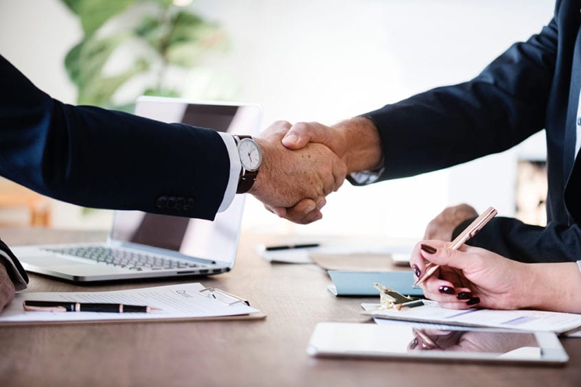 Two business people shaking hands