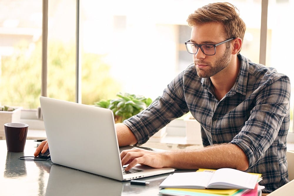 A man looking up 721 exchanges on his computer