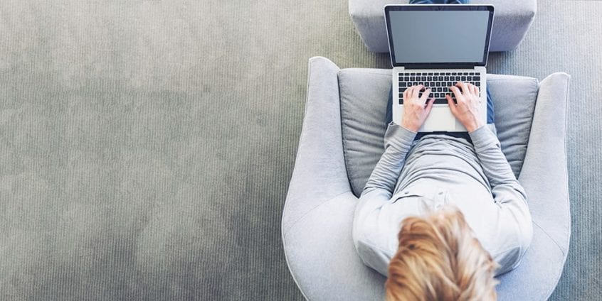 A woman looking up 1031 exchange triple net leases on her computer